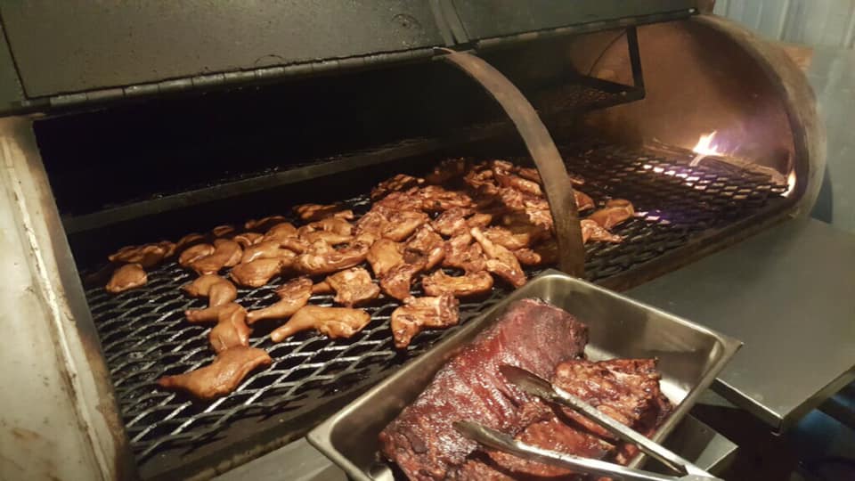 Grill with barbecue chicken and smoked ribs
